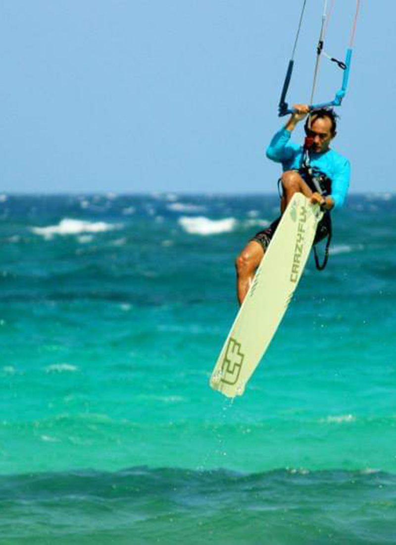 Kitesurfer carving across Boca Grandi's trade-wind chop — the southern kite spot five minutes from Kite Inn